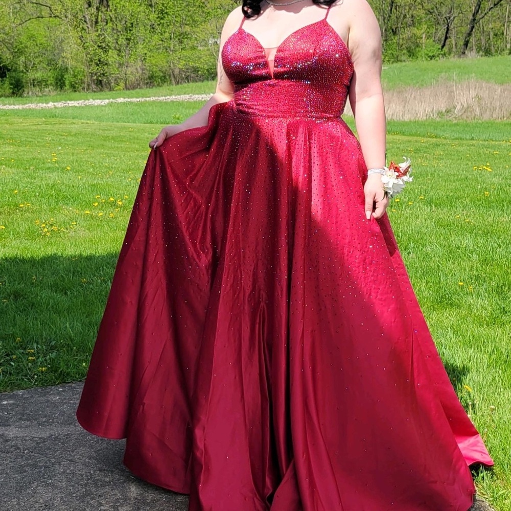 Red ball gown prom dress, covered in rhinestones. No alliterations